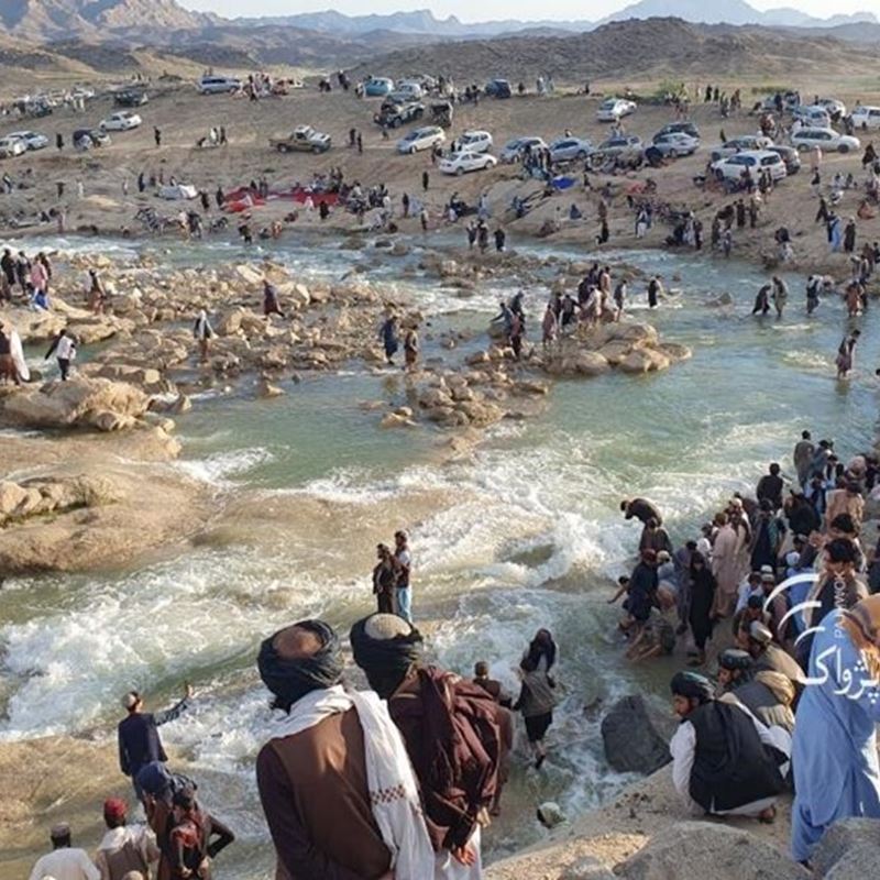 Tourists enjoy excess waterflow from the dam released to the local river in Kandahar province. Photo taken from social media/PAN
